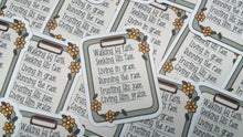 Load image into Gallery viewer, A close-up of multiple identical decorative labels or stickers arranged on a white surface. Each label has a rounded rectangular border, a gray inner frame, black printed text, and yellow flower illustrations with green leaves.