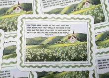 Load image into Gallery viewer, A close-up of printed cards or labels with a green and white scalloped border, featuring a small scenic illustration and blocks of text. Multiple copies are spread out on a surface.