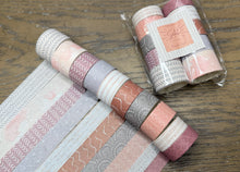 Load image into Gallery viewer, Ten rolls of decorative washi tape with pink, gray, and peach patterns, alongside a packaged set of matching rolls on a wooden surface.
